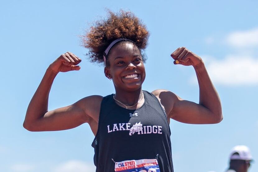 Mansfield Lake Ridge's Jasmine Moore poses after jumping a wind-aided 45 feet, 4.75 inches...