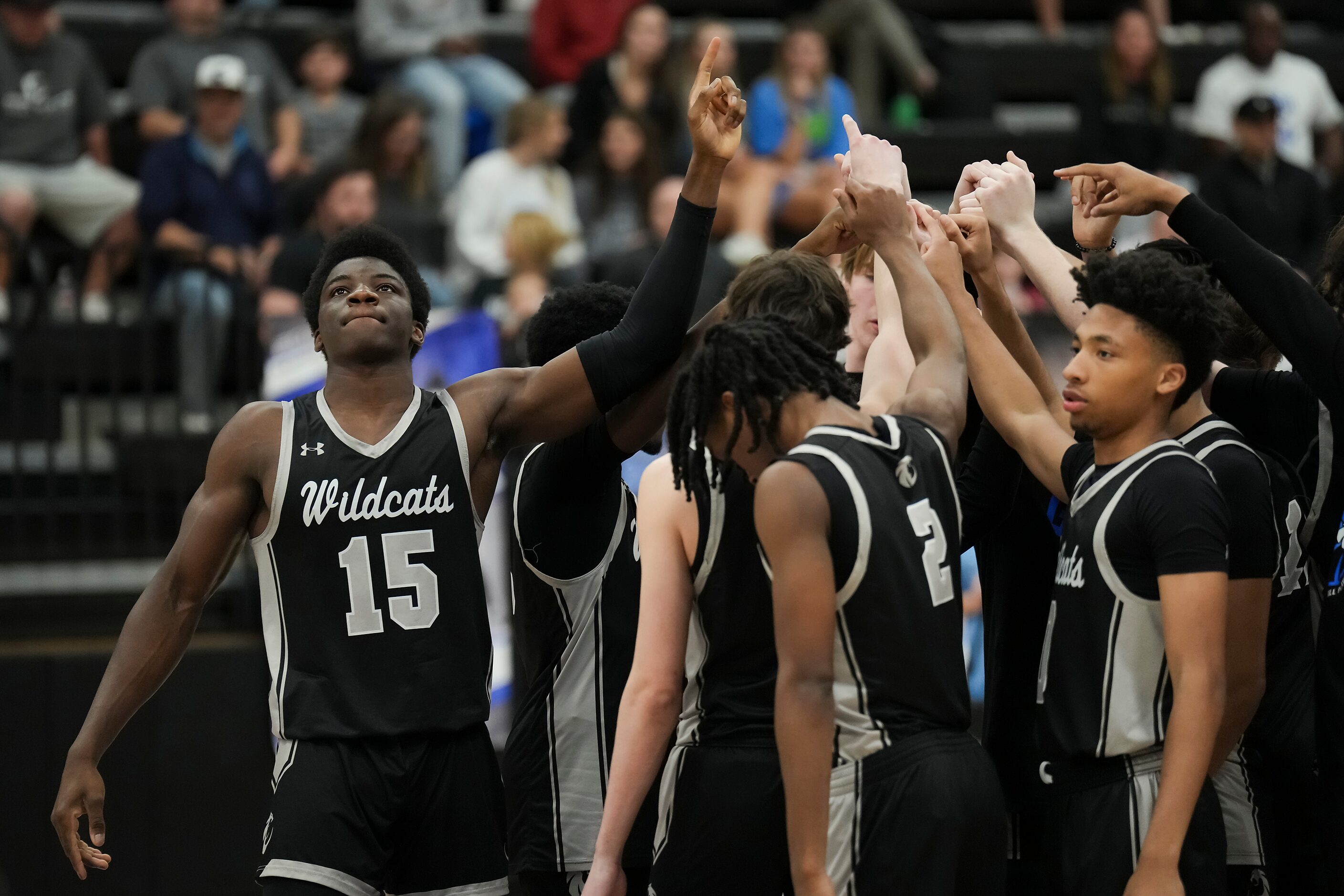 Denton Guyer forward Akintola Akinniyi (15) huddles with teammates before the first half of...