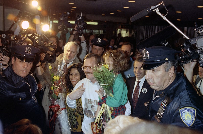 FILE - Former hostage Terry Anderson, center, carries his daughter Sulome, 6, through a...