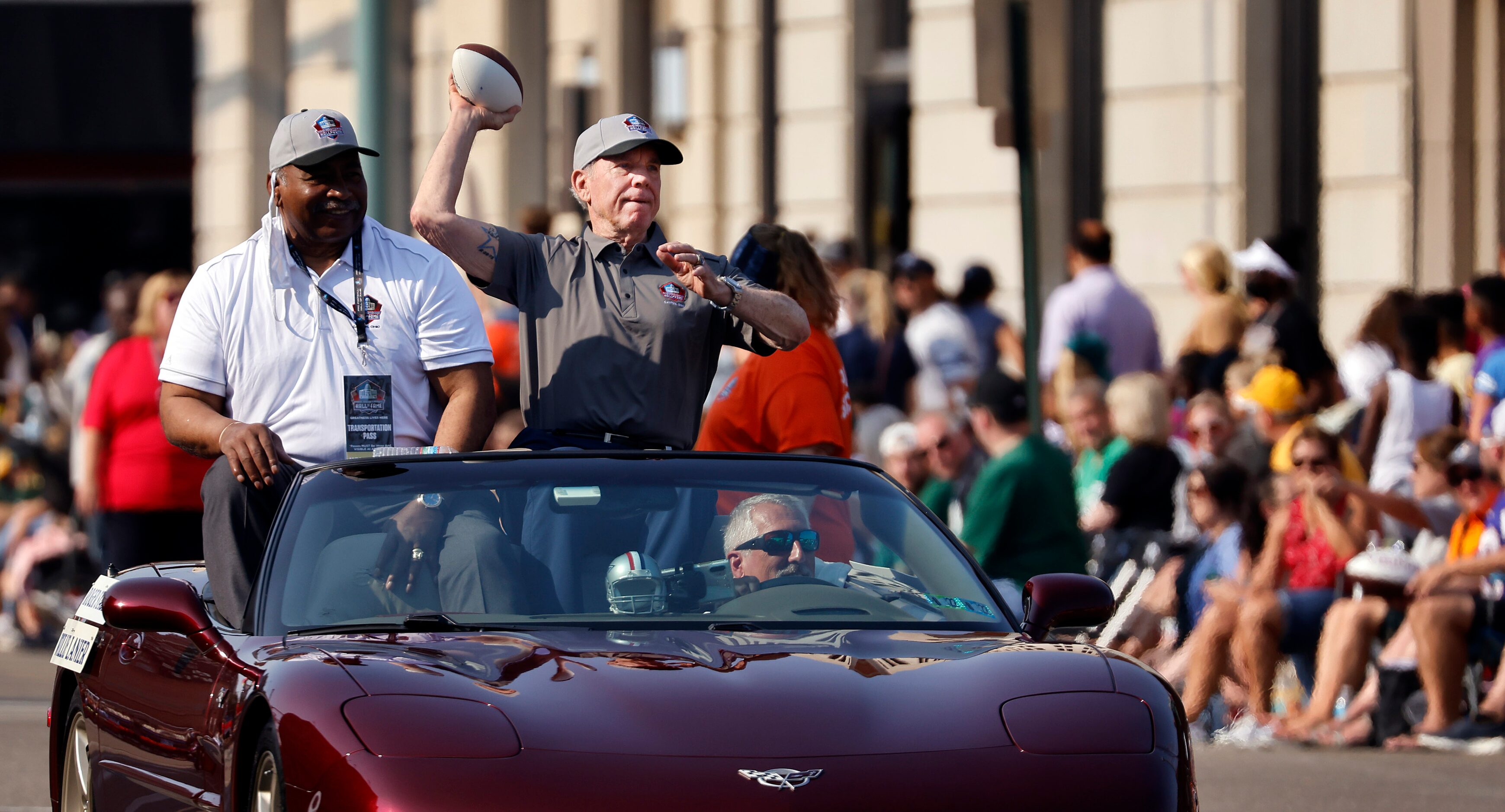 Dallas Cowboys Pro Football Hall of Fame quarterback Roger Staubach throws a pass to a kid...