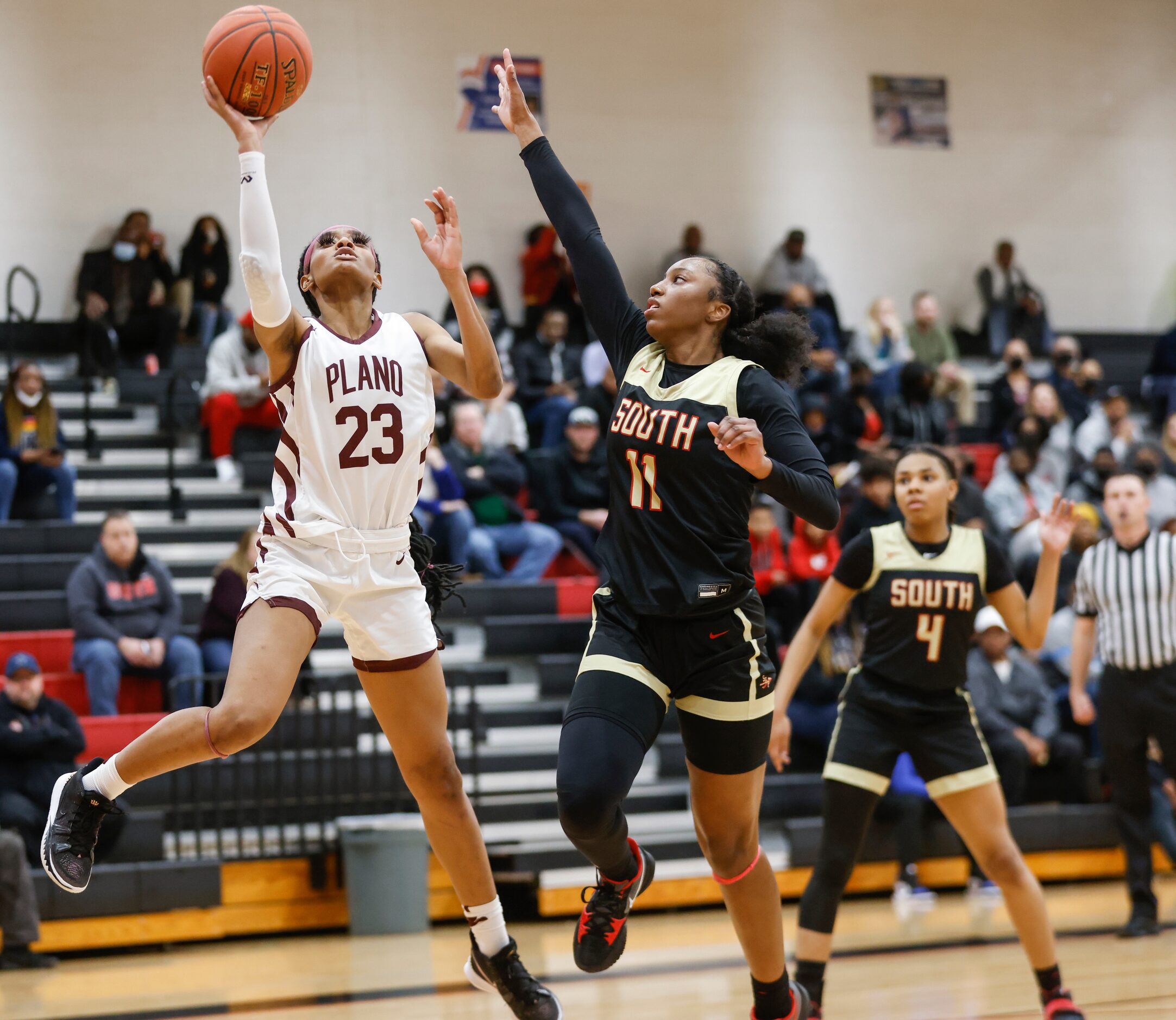 Plano Senior High School Jaden Berry (23) shoots the ball while defended by South Grand...