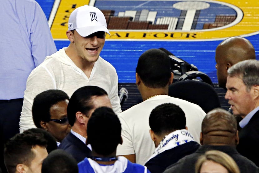 Texas A&M quarterback Johnny Manziel makes his way to his seat as the Kentucky Wildcats...