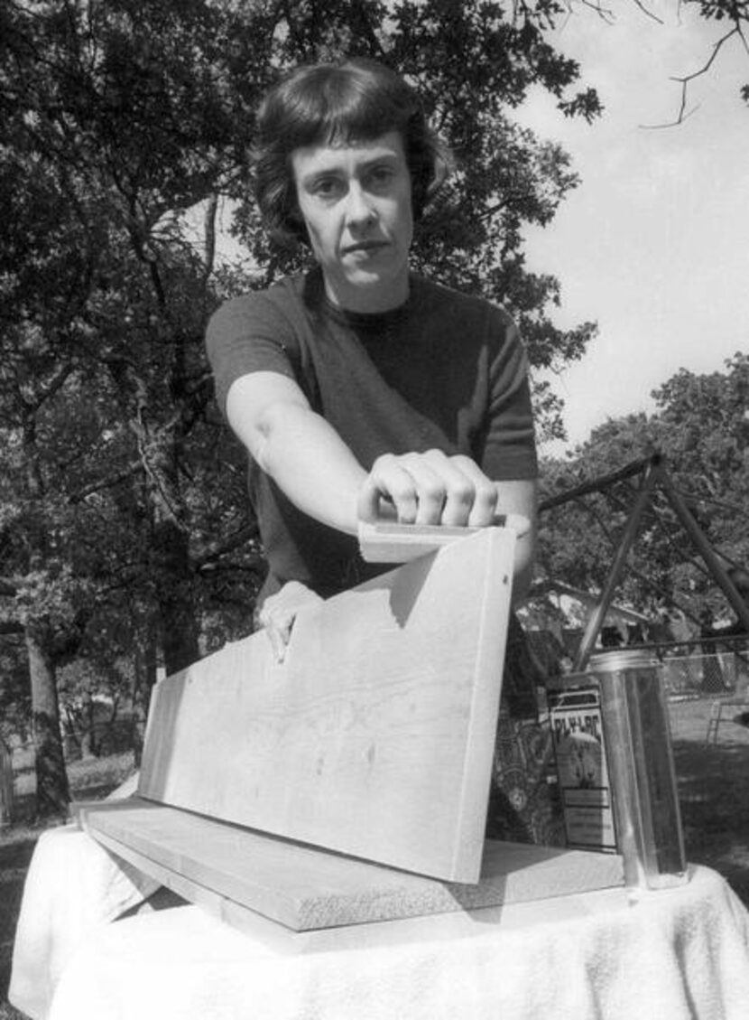 
Ruth Paine is shown in this October 1963 photo in her Irving backyard sanding shelves for a...