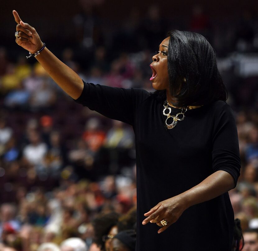 Dallas Wings head coach Taj McWilliams-Franklin calls out a play to her team as they play...