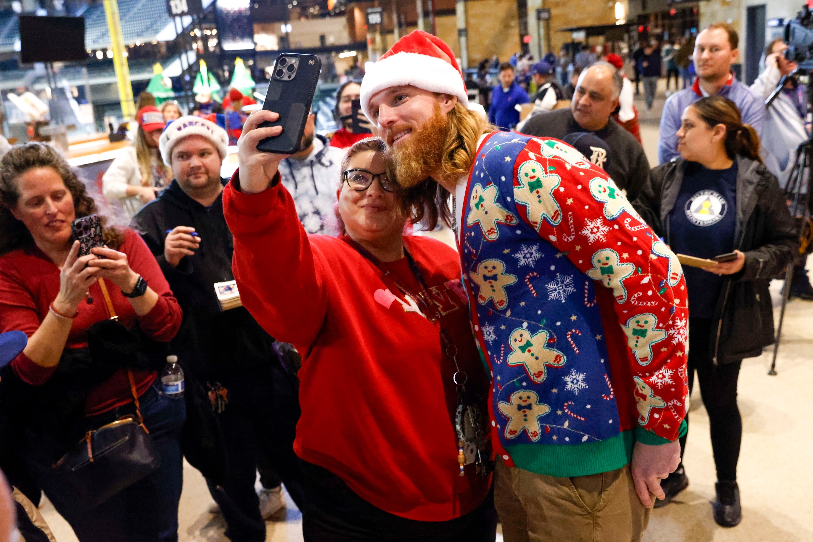 Texas Rangers pitcher Jon Gray takes photos with fans  during Texas Rangers Toy Drive on,...