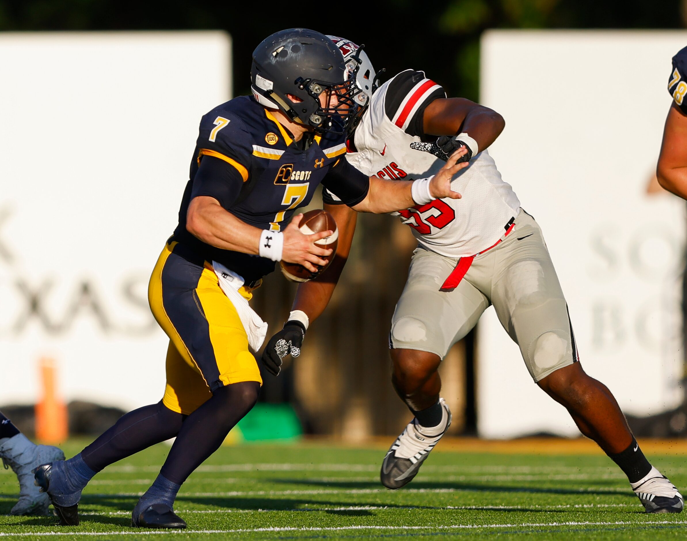 Highland Park quarterback Brennan Storer (7) dodges Flower Mound Marcus’ defensive lineman...