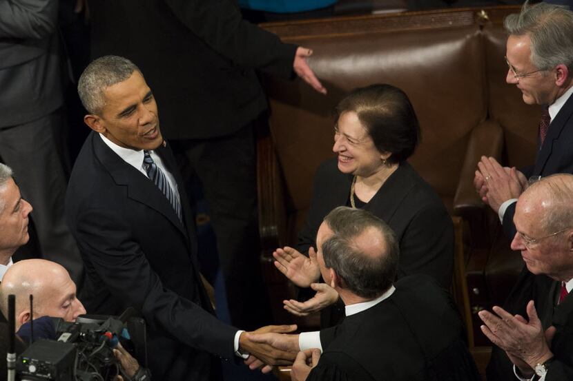  U.S. President Barack Obama, left, shakes hands with Supreme Court Justices John Roberts...