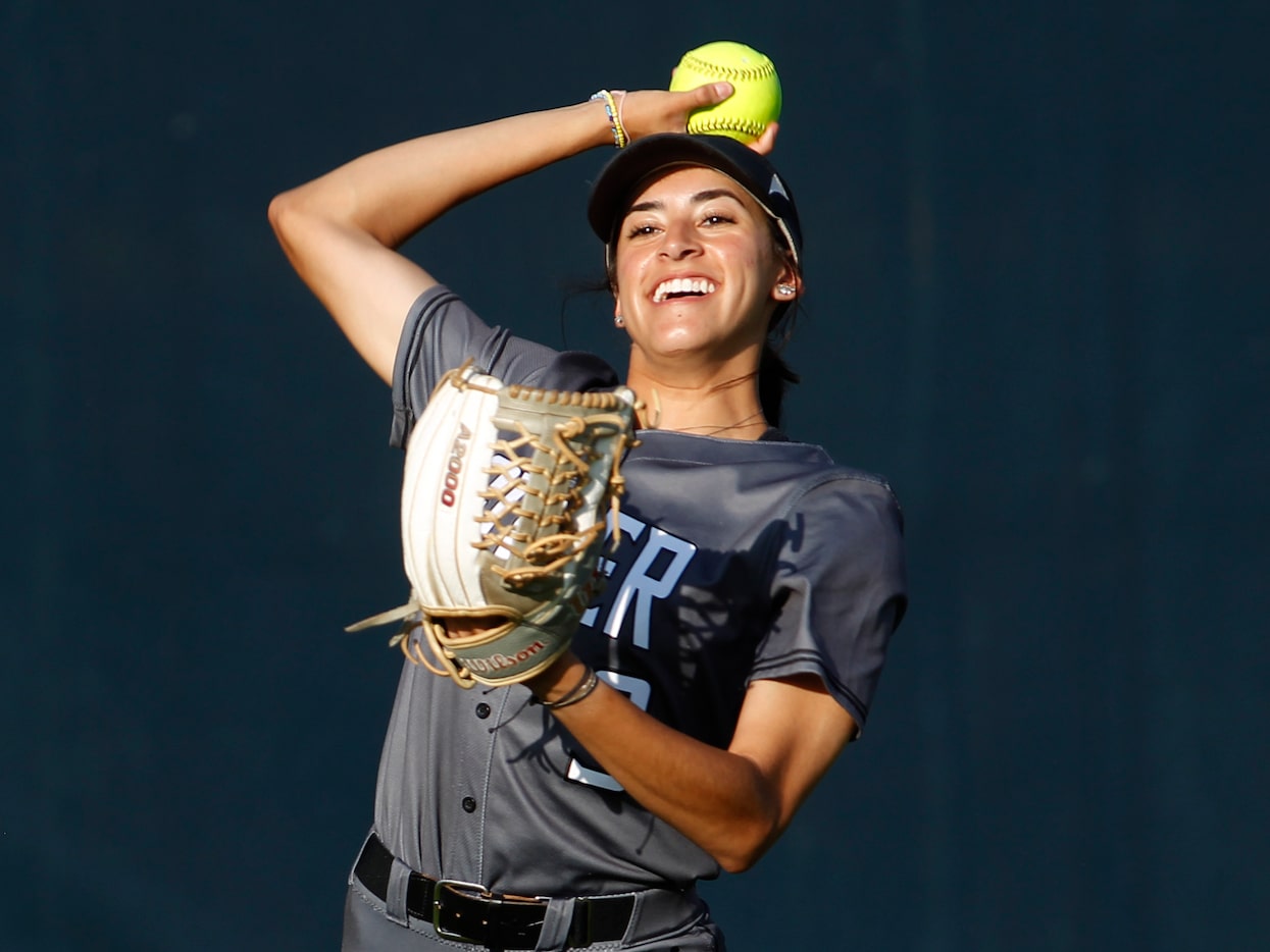 Denton Guyer outfielder Karen Galaviz, (9) warms up with a teammate before the start of...