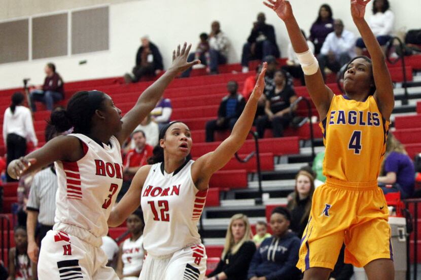 Richardson point guard Dorian Branch (4) attempts a jump shot while defended by Jonna...