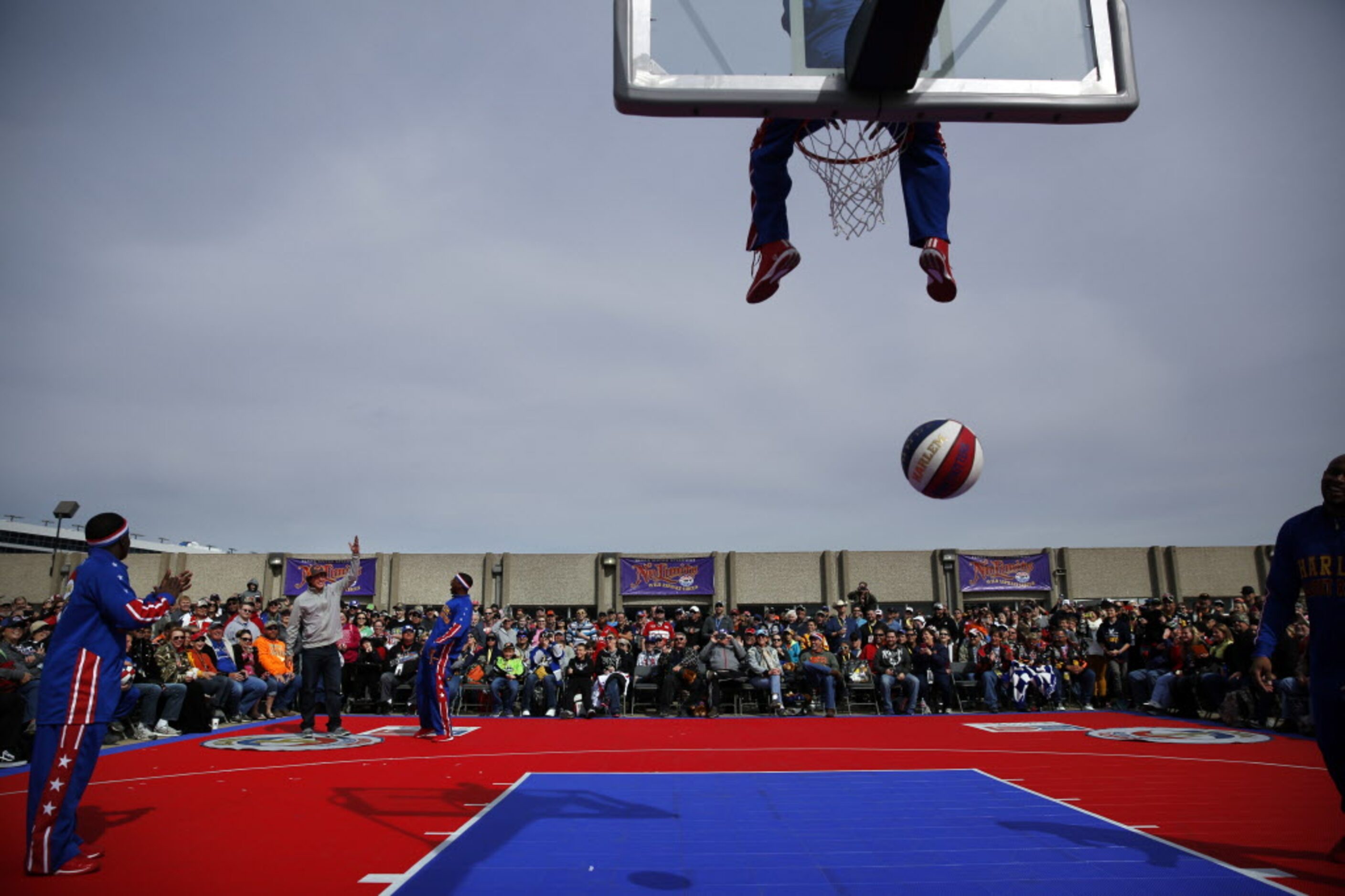 Texas Rangers pitcher Derek Holland (left) received an assist from the Harlem Globetrotters...