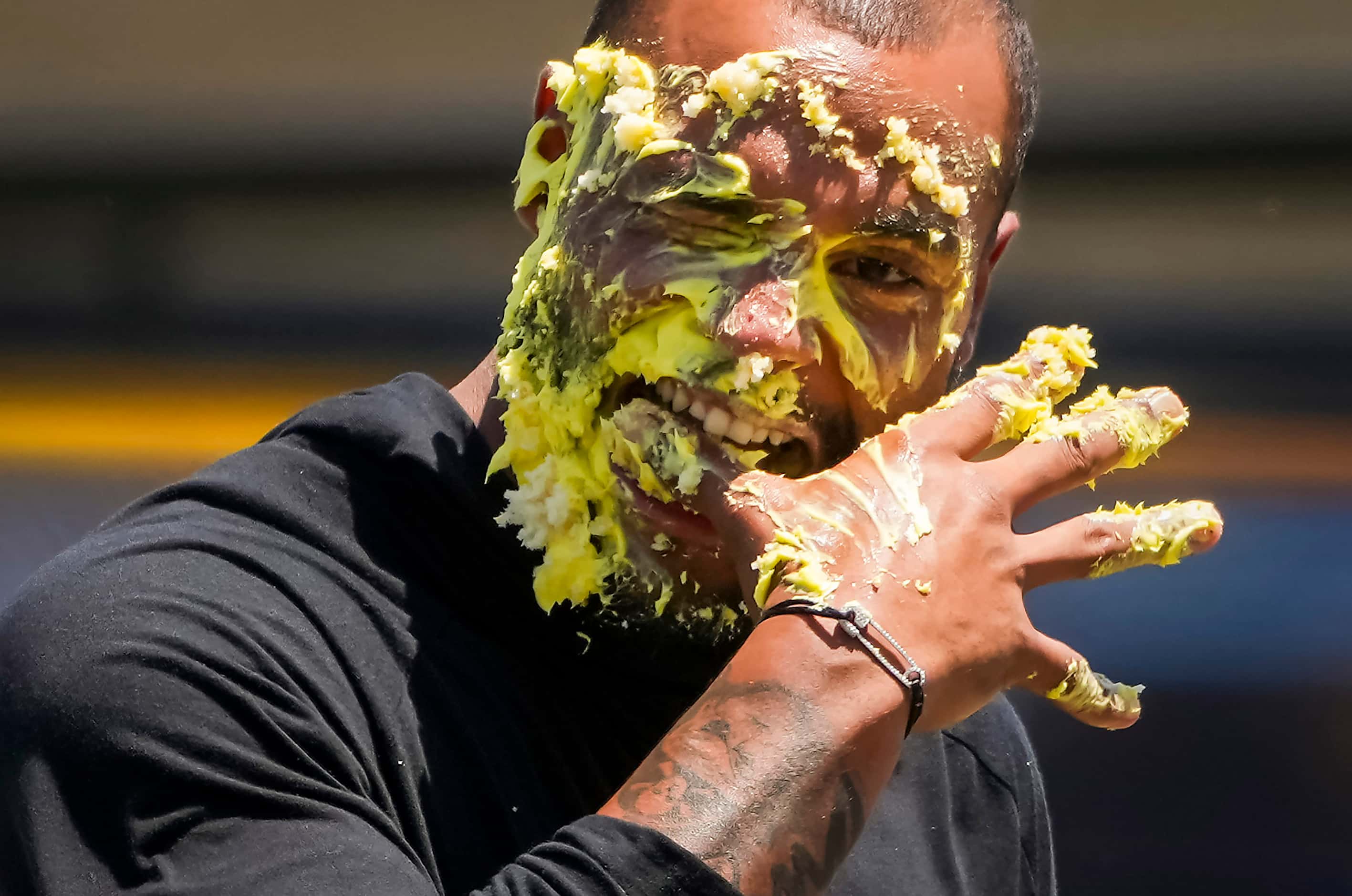 Dallas Cowboys quarterback Dak Prescott licks icing off his fingers after getting a cake to...