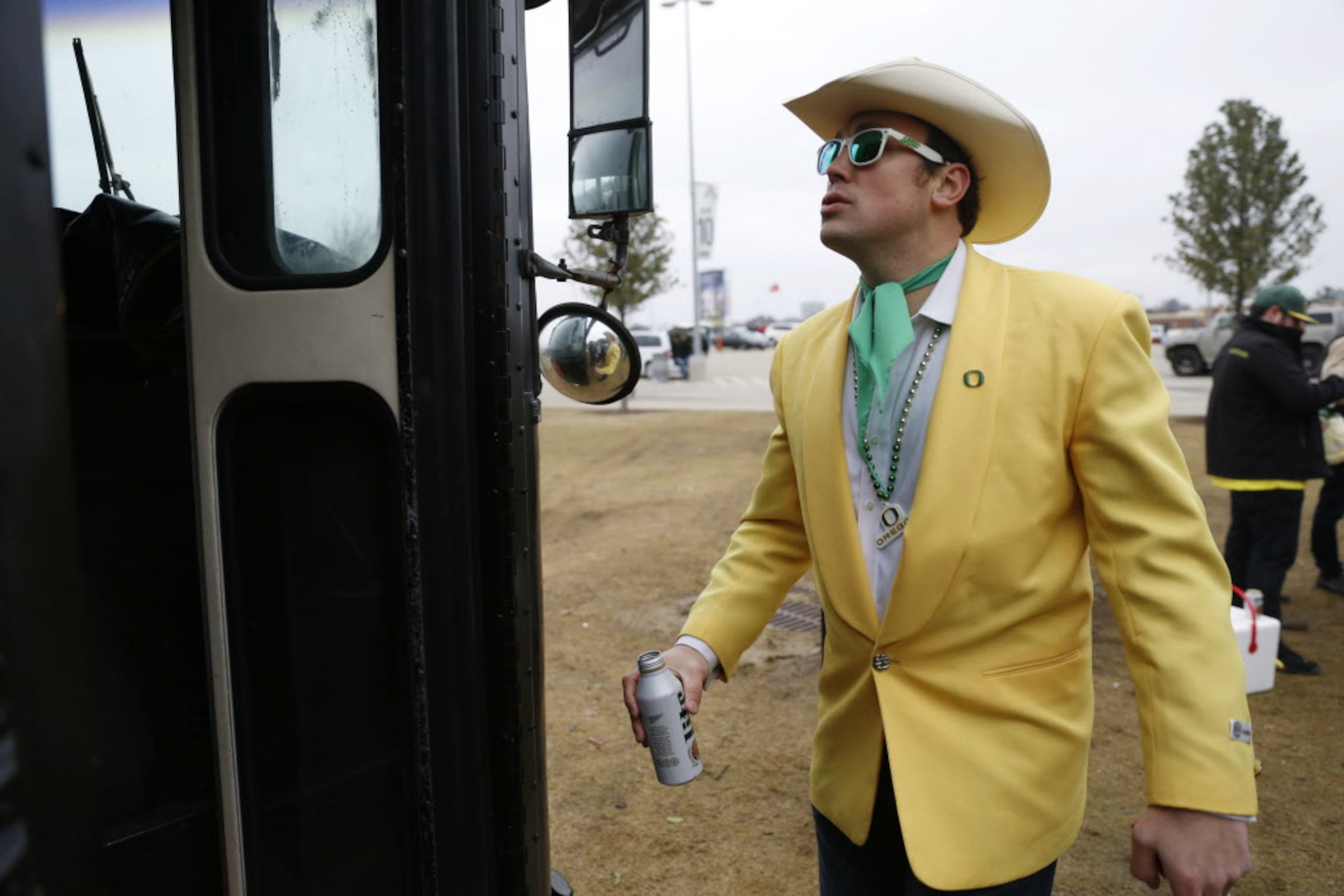 Oregon Ducks fans Clay Wraith, of Nashville, Tennessee, looks into a tailgating bus before...