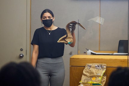 Ola Moussa displays a bag of evidence during the trial of Ruben Alvarado on Tuesday.