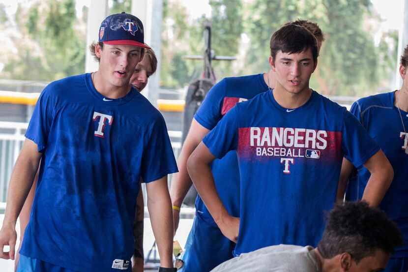 FILE - Rangers pitchers Mason Englert (left) and Owen White (right) watch a drill that works...