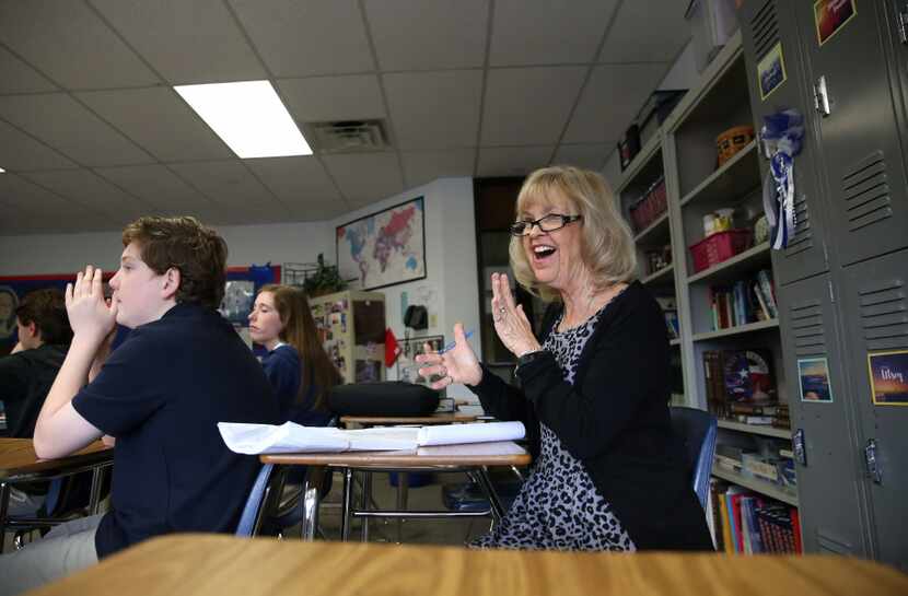 LuAnn Dolly, American history teacher, claps after an eighth grade student recites the Star...