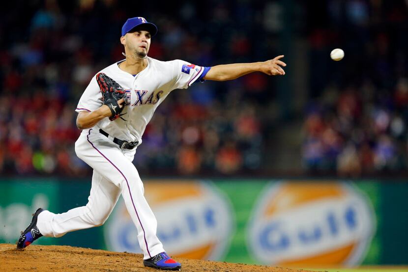 Texas Rangers relief pitcher Alex Claudio (58) throws against the Milwaukee Brewers in the...