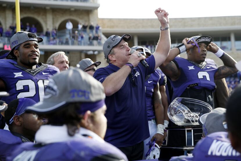 TCU head coach Gary Patterson congratulates fans during a trophy presentation after earning...