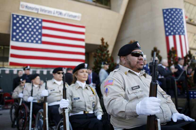 The Lone Star Paralyzed Veterans of America prepare to give a rifle salute at a Dallas...