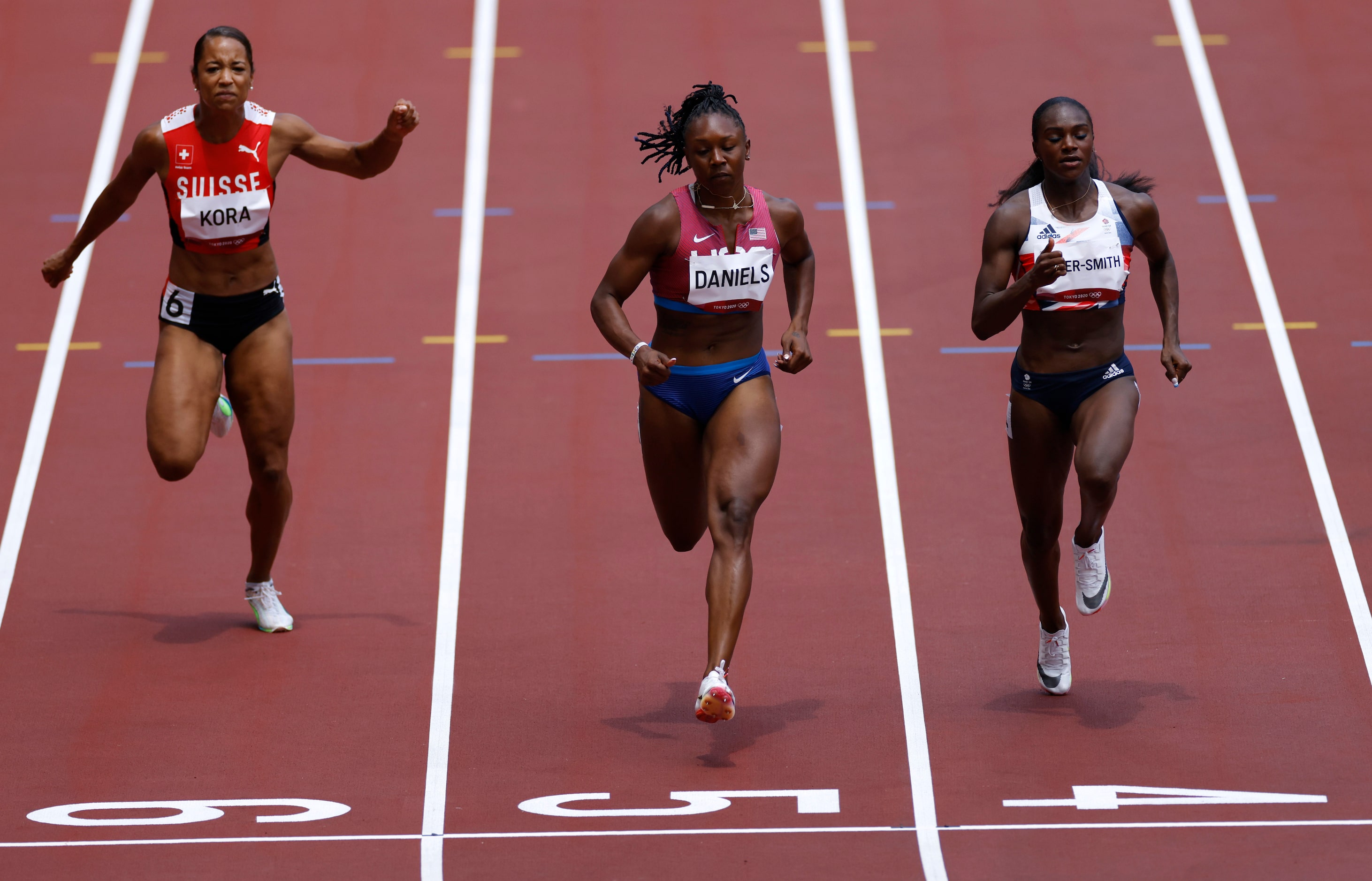 Switzerland’s Salome Kora, USA’s Teahna Daniels and Great Britain’s Dina Asher-Smith compete...