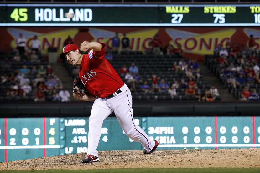 Texas Rangers starting pitcher Derek Holland (45) throws in the ninth inning against the...