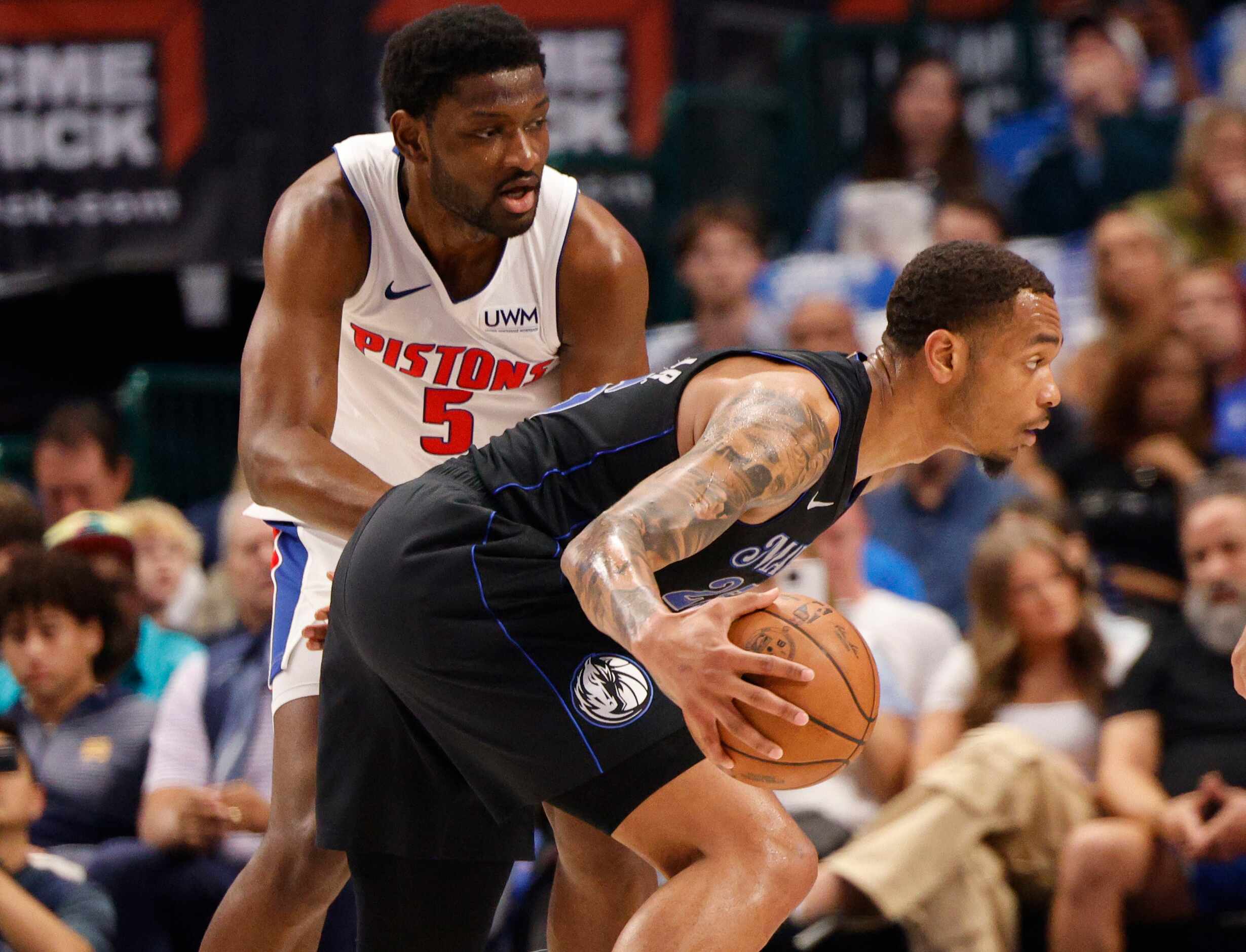 Dallas Mavericks forward P.J. Washington (25) tries to drive past Detroit Pistons forward...