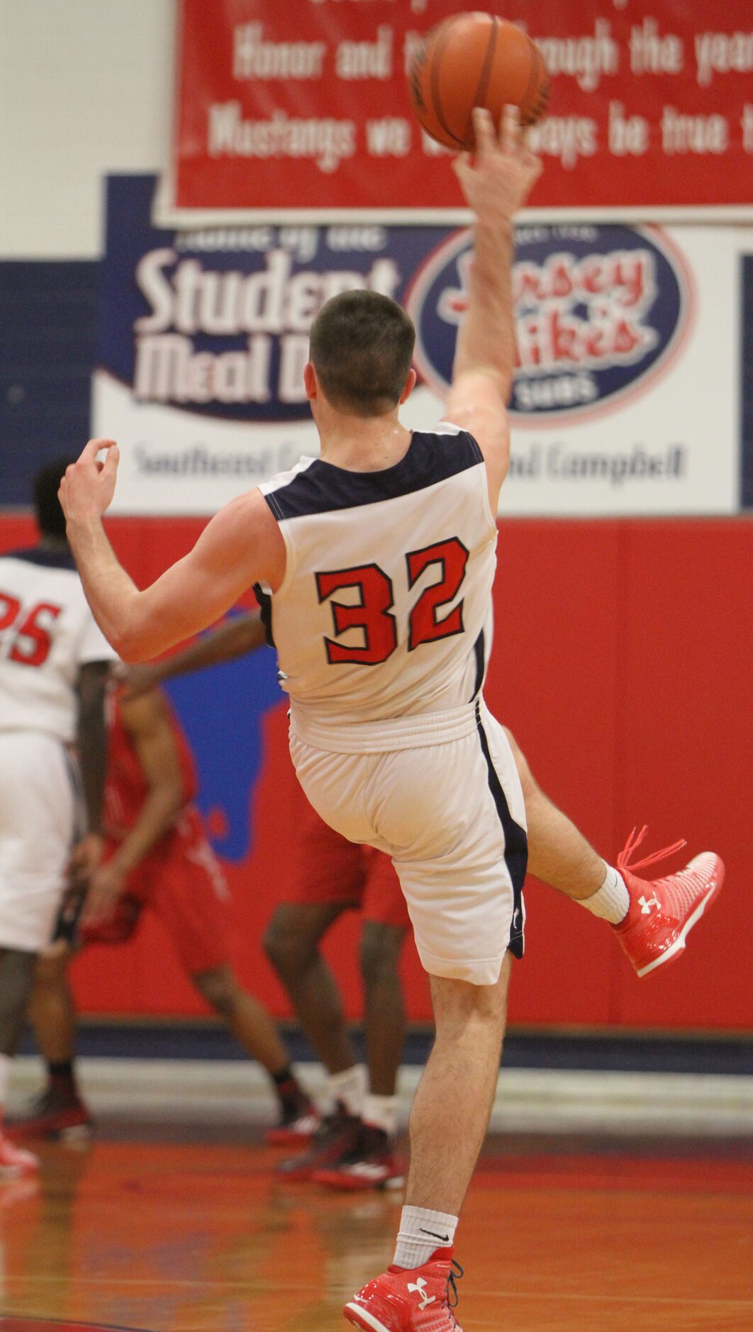 Frisco Centennial forward John Robbins (32) delivers an off balanced pass to a teammate...