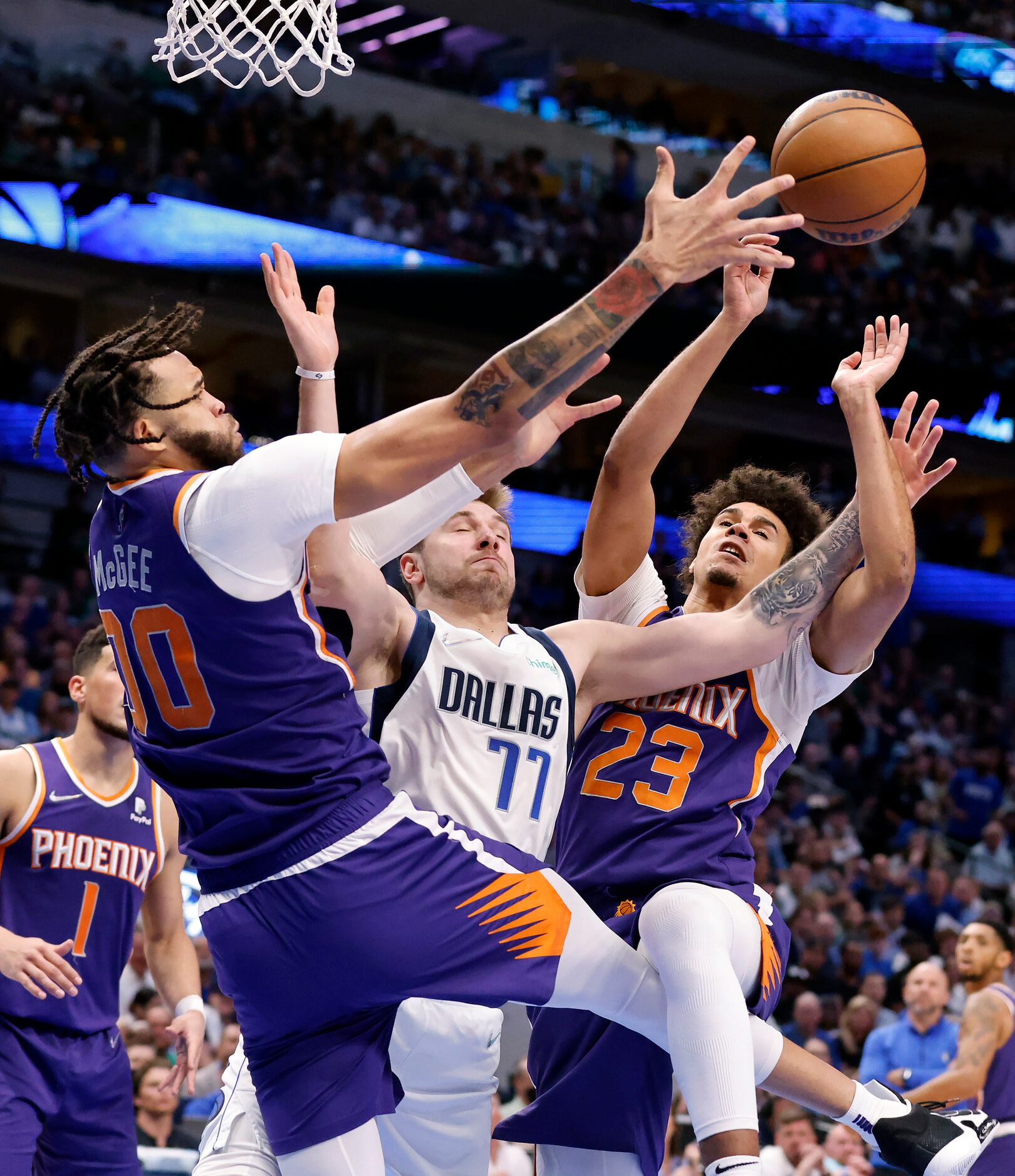 Dallas Mavericks guard Luka Doncic (77) goes up for an offensive rebound and is fouled as he...