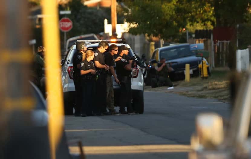 Officers swarmed the area near where suspects were shot following a mass shooting at the...