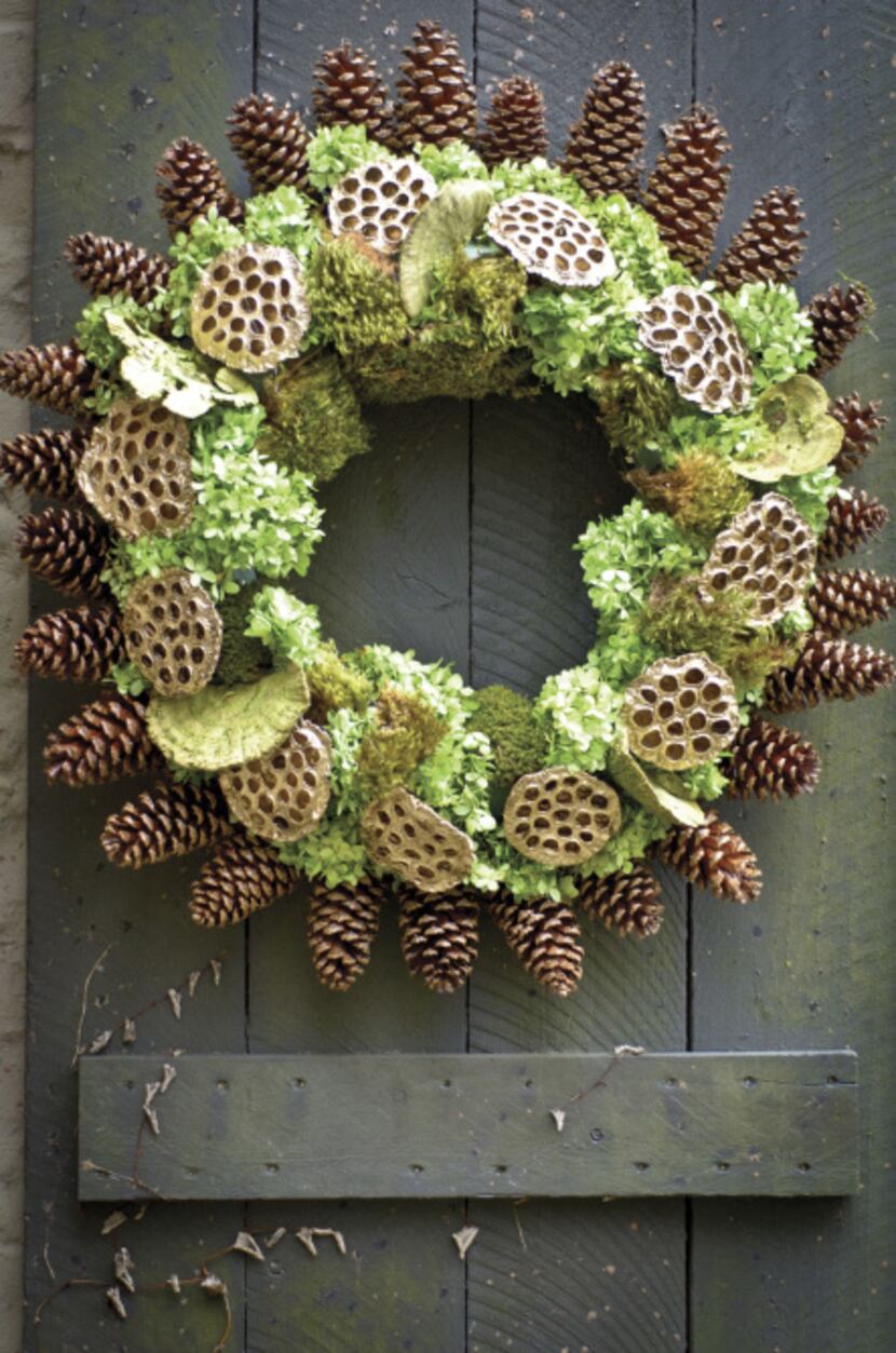 A radiating rim of pine cones with lotus pods, preserved tree fungi, hydrangeas and moss...