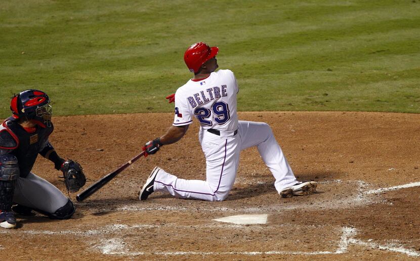 Twisting to his knee on the follow through, Texas Rangers batter Adrian Beltre homered to...
