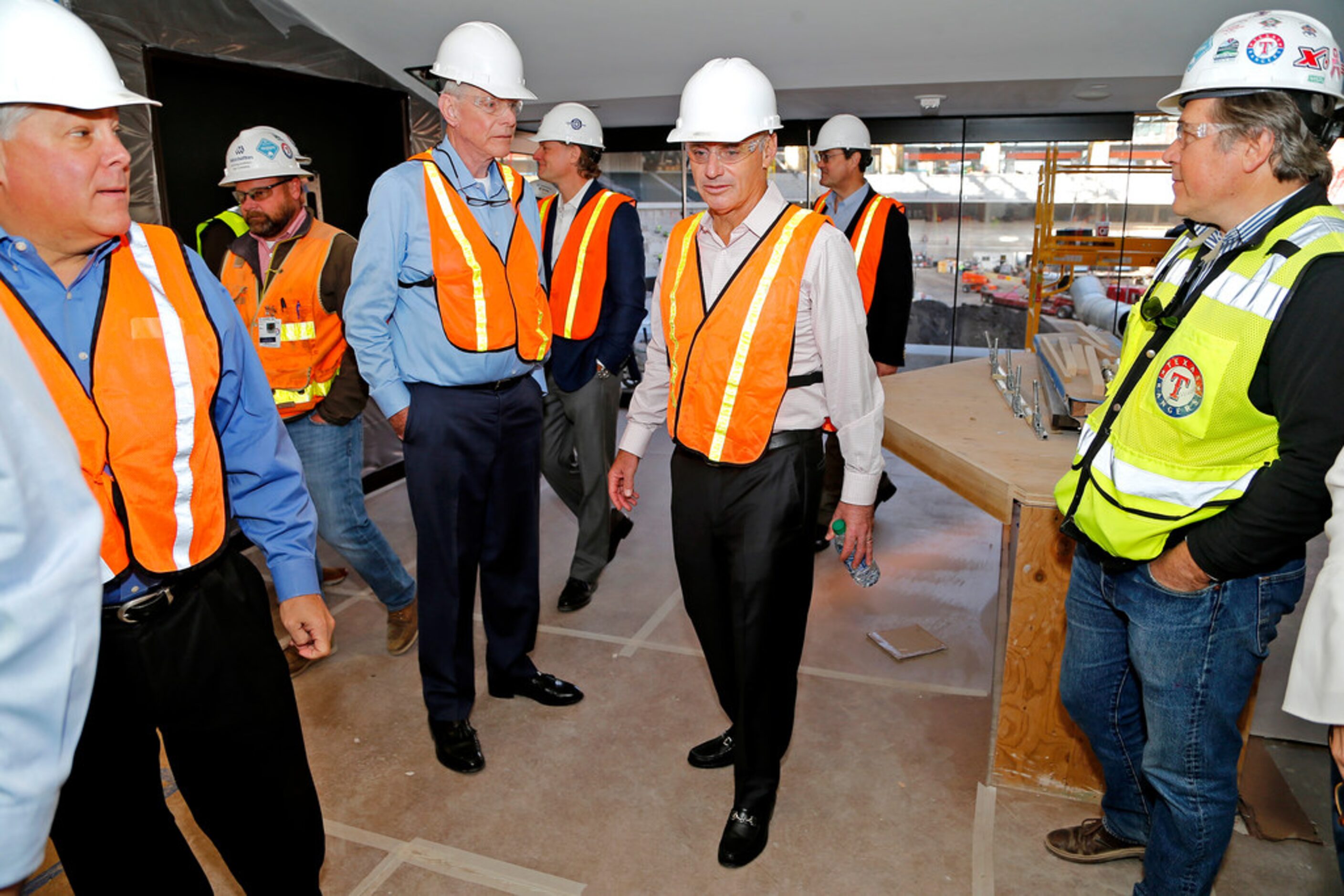 MLB commissioner Rob Manfred (center) checks out a suite with Texas Rangers officials as...