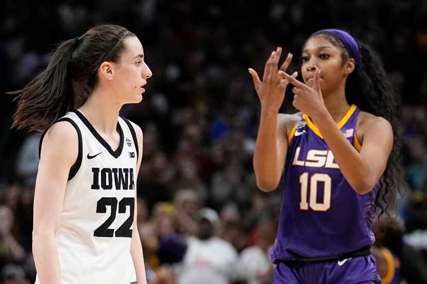 LSU's Angel Reese reacts in front of Iowa's Caitlin Clark during the second half of the NCAA...