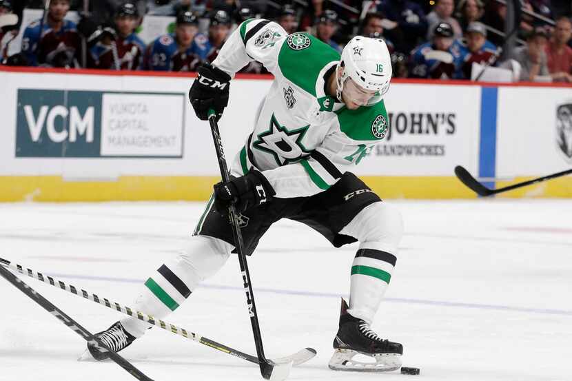 Dallas Stars center Jason Dickinson moves the puck against the Colorado Avalanche during the...
