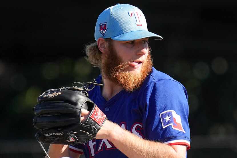 Texas Rangers pitcher Zak Kent delivers during the sixth inning of a spring training game...