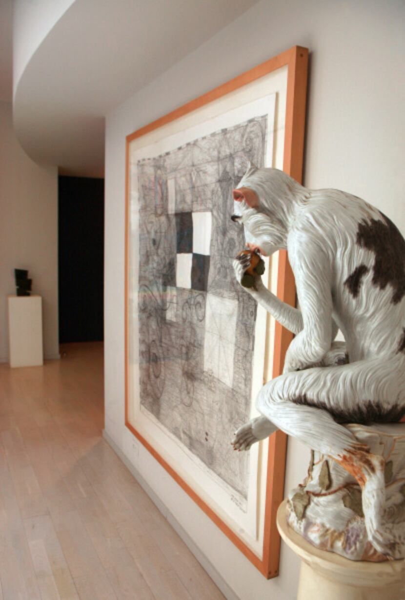A giant Meissen monkey watches over the entry hall. The framed work on paper is I Ran A Muck...