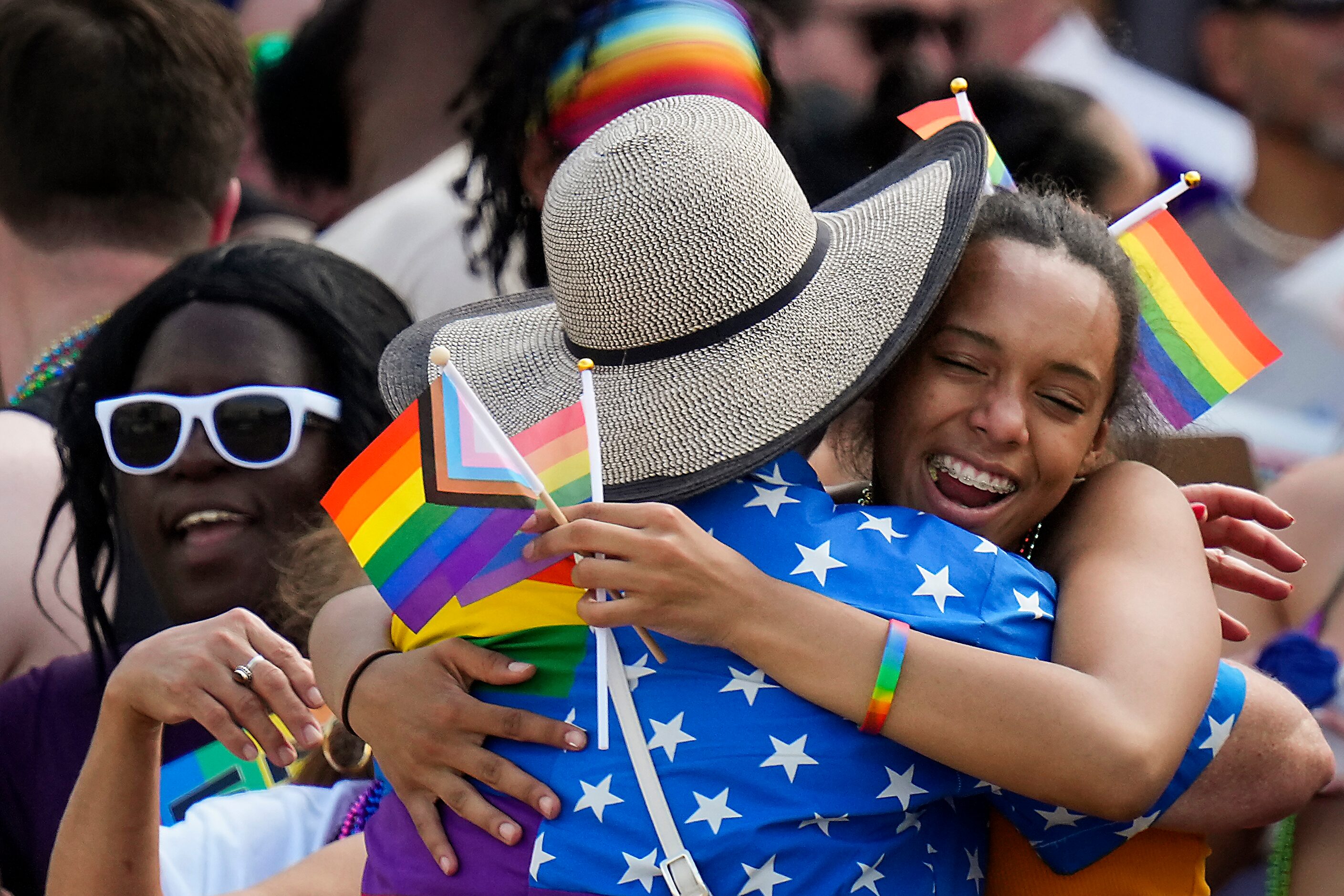 Spectator Cleo Gonzalez gets a hug from Kelly Hazard of the group Free Mom Hugs during the...