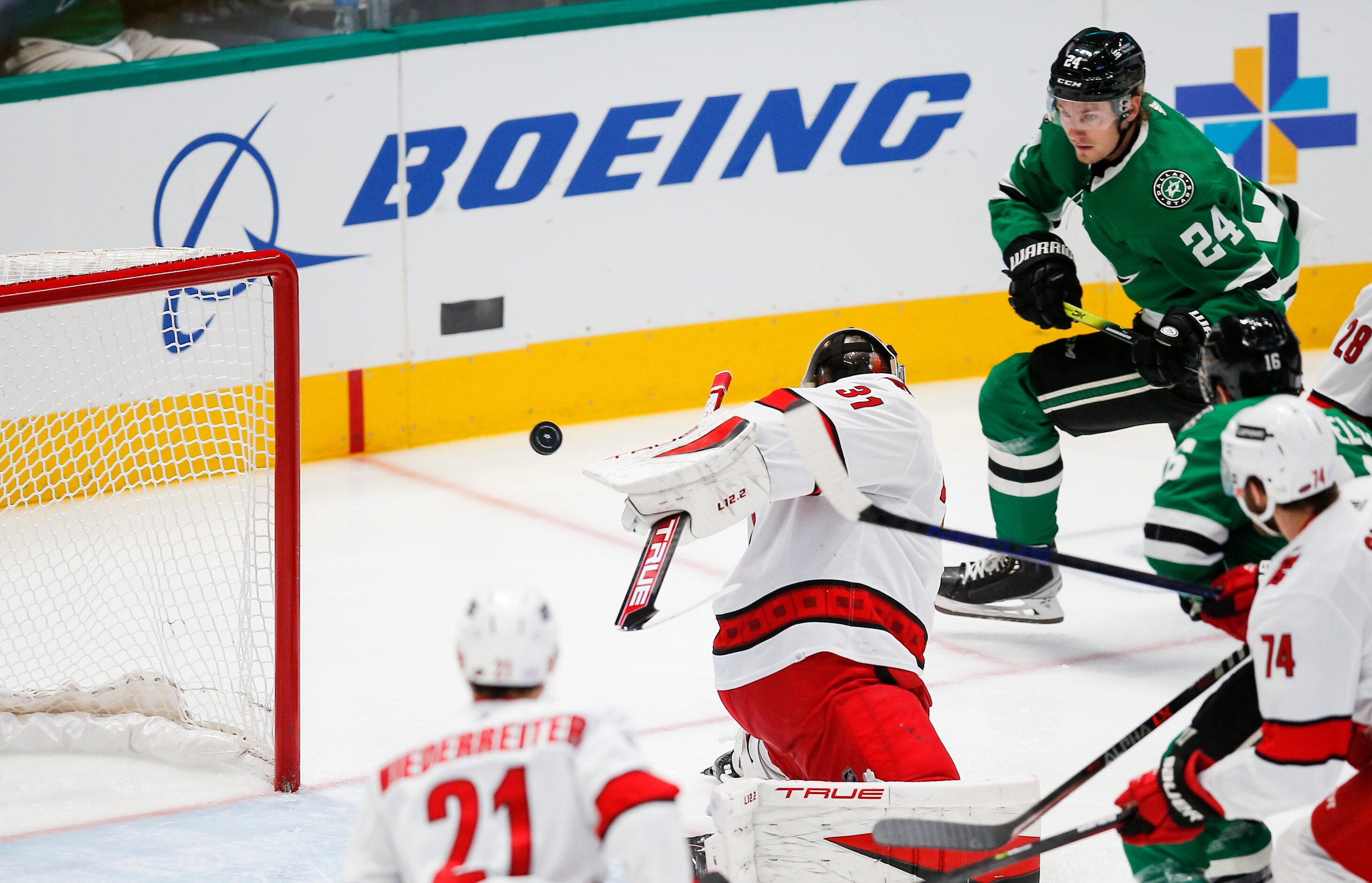 Dallas Stars forward Roope Hintz (24) shoots the puck past Carolina Hurricanes goaltender...