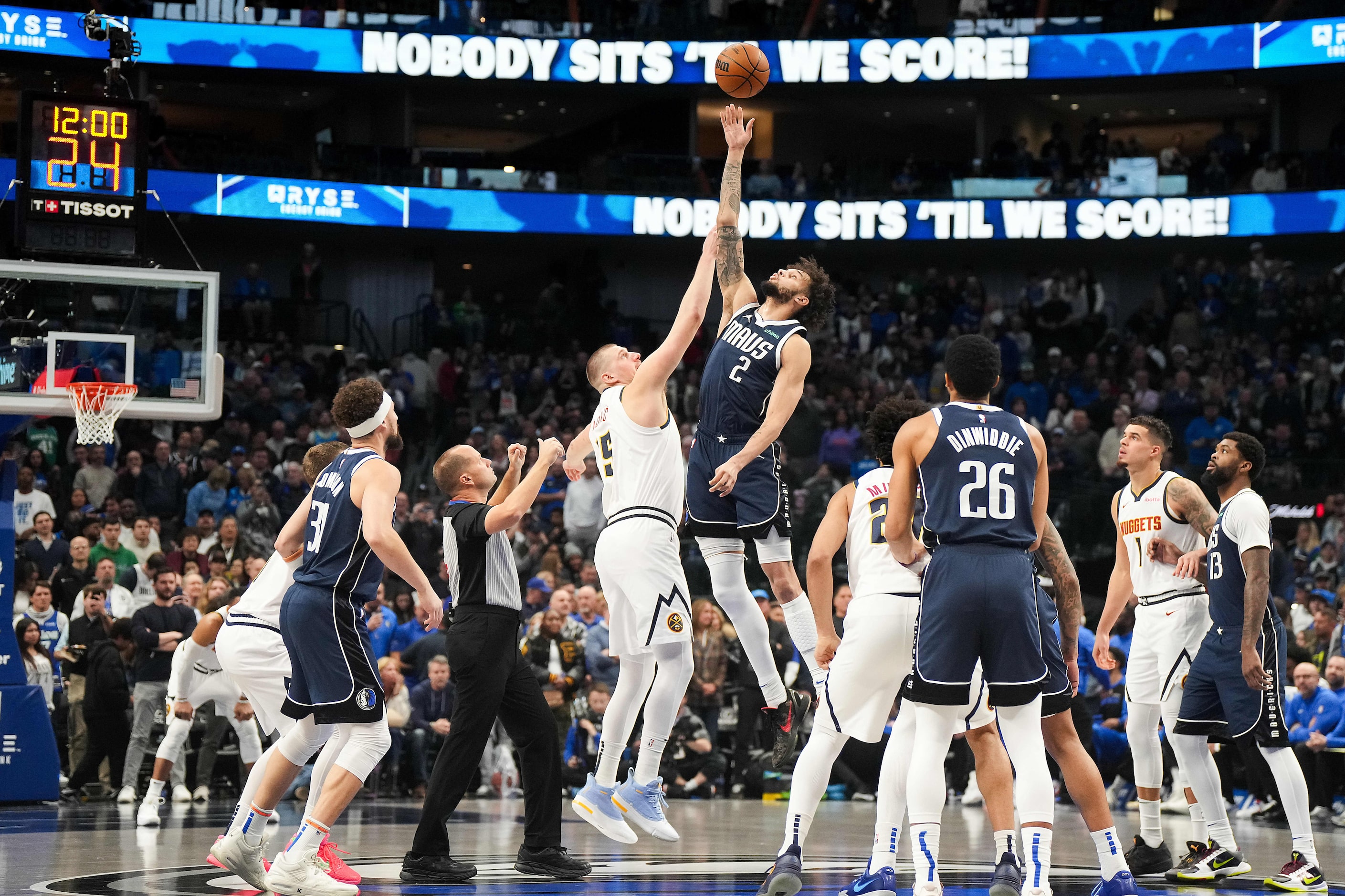 Dallas Mavericks center Dereck Lively II (2) wins the opening tipoff against Denver Nuggets...