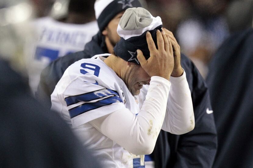 Dallas Cowboys quarterback Tony Romo (9) reacts on the bench after he threw an interception...