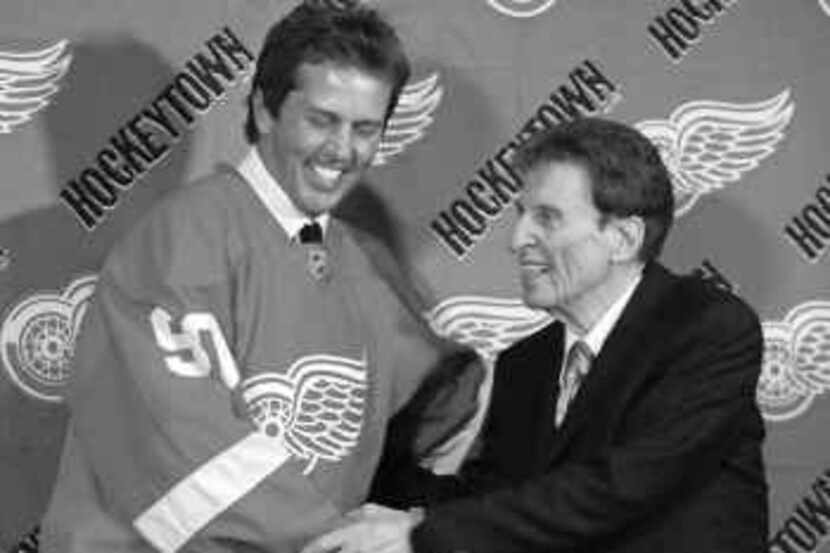  Mike Modano, introduced to Detroit media by Red Wings owner Mike Ilitch, will play against...