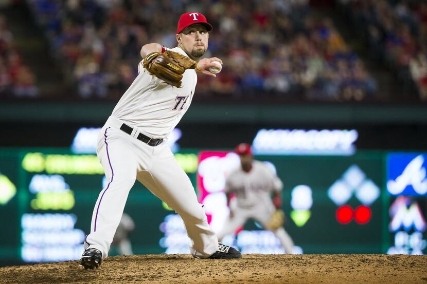 Texas Rangers relief pitcher Andrew Faulkner delivers a pitch during the seventh inning...