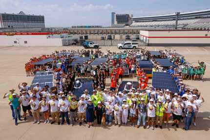 High school students from around the country pose for a photo for with their solar cars.
