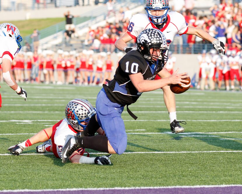 Plano West's Travis Korry (10) dives into the end zone for a touchdown against Austin...