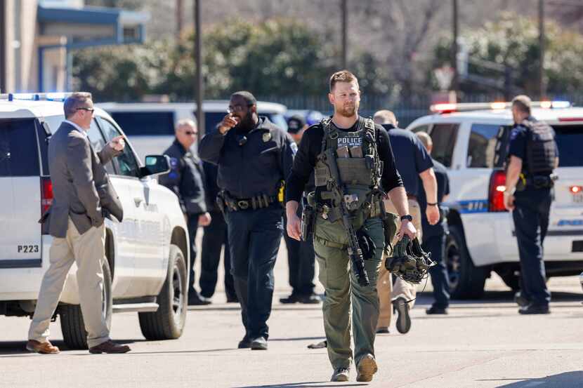 A Mesquite police S.W.A.T officer works the scene after a shooting at Pioneer Technology and...