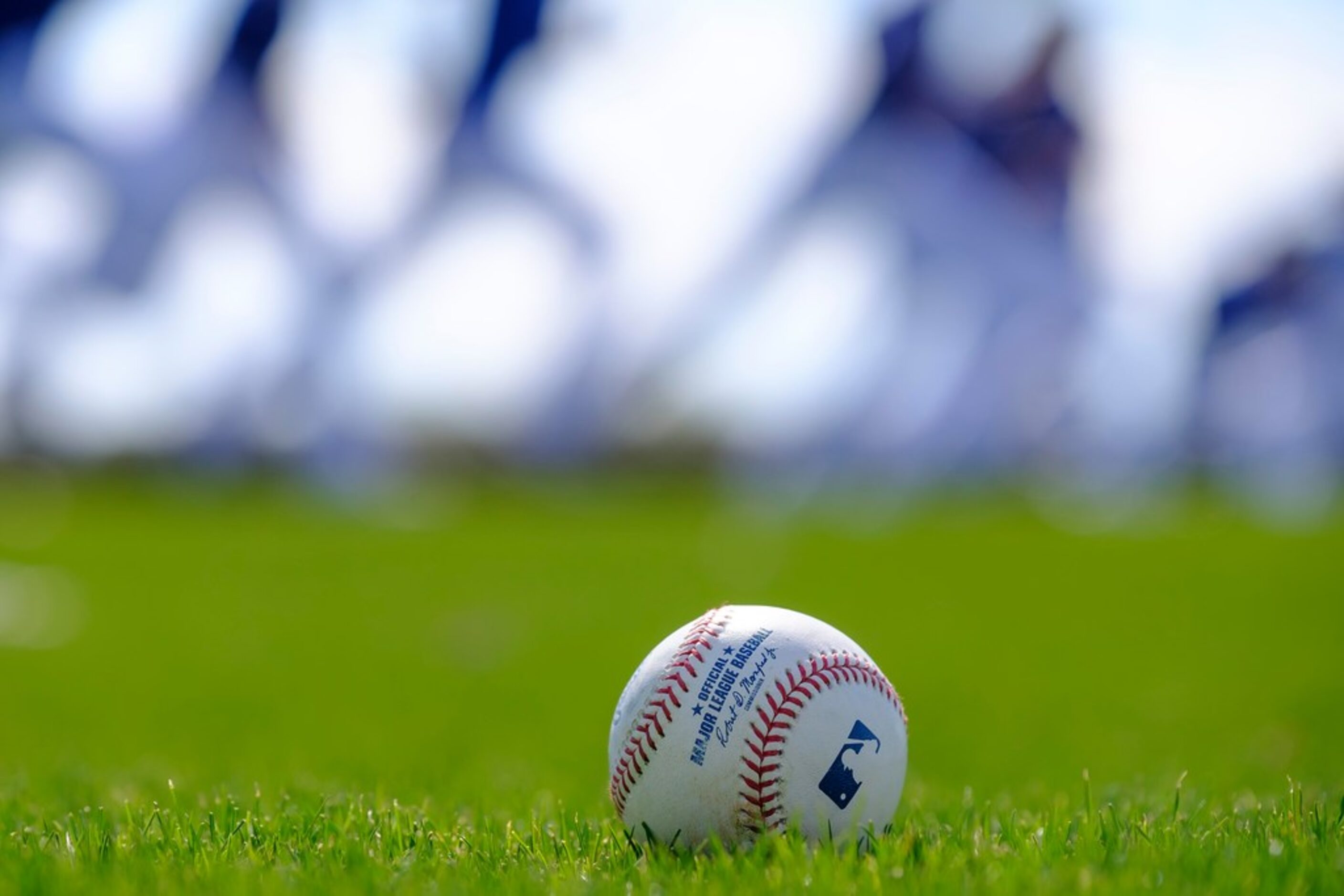 Texas Rangers pitchers run on a conditioning field during a spring training workout at the...