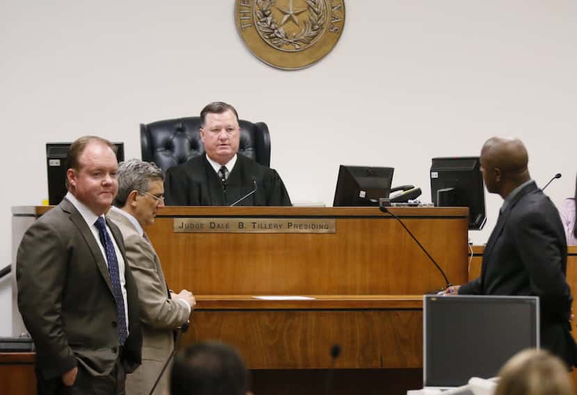 Judge Dale B. Tillery, center, talks with attorneys from both side during a hearing in the...
