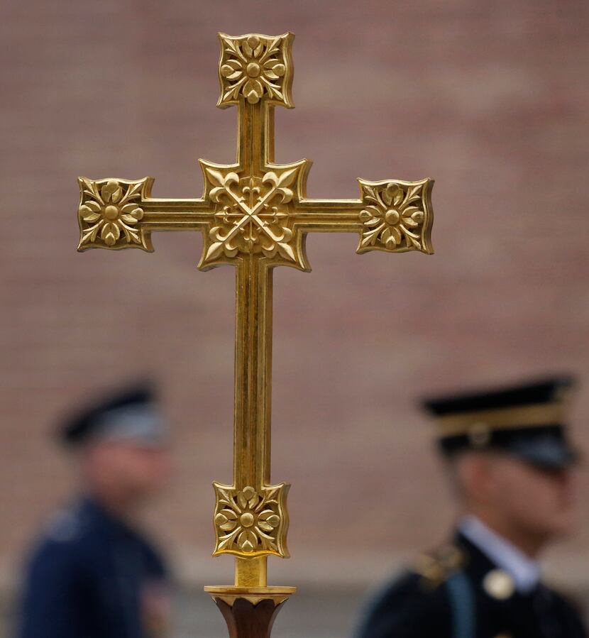 The cross is carried back into the church after the funeral service for George H.W. Bush,...