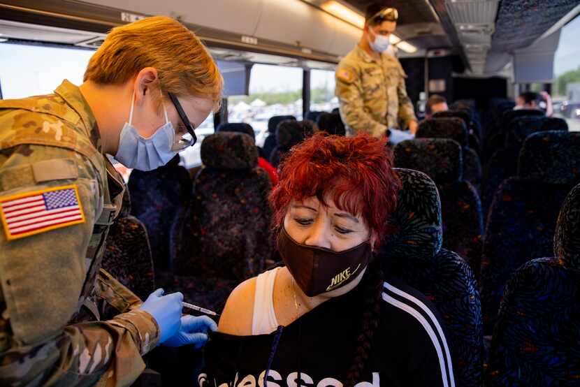 Rosa Sanchez received her vaccine aboard a bus April 7 at Fair Park. Dallas County provided...