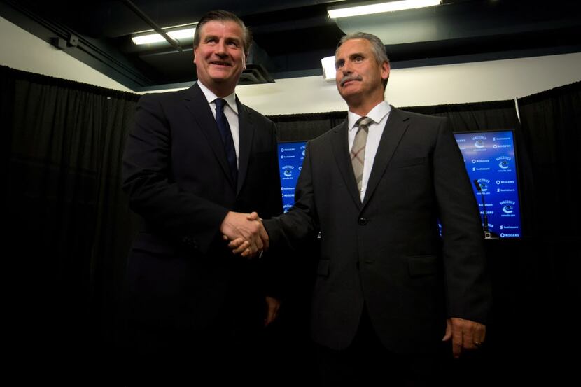 Vancouver Canucks' general manager Jim Benning, left, and new head coach Willie Desjardins...