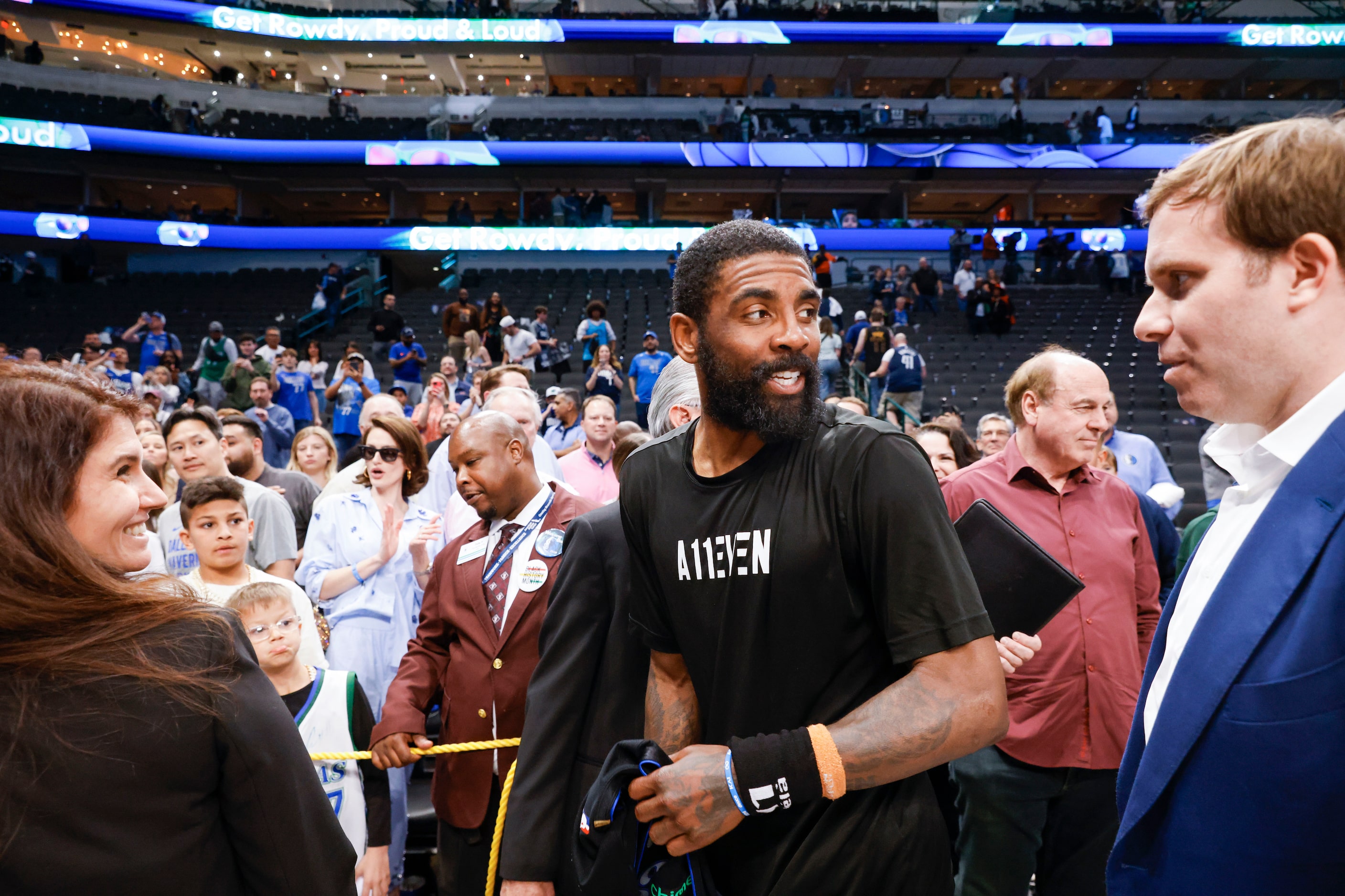 Dallas Mavericks guard Kyrie Irving (left) talks to Dallas Mavericks Governor Patrick Dumont...